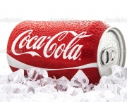 Can of Coca-Cola on a bed of ice over a white background